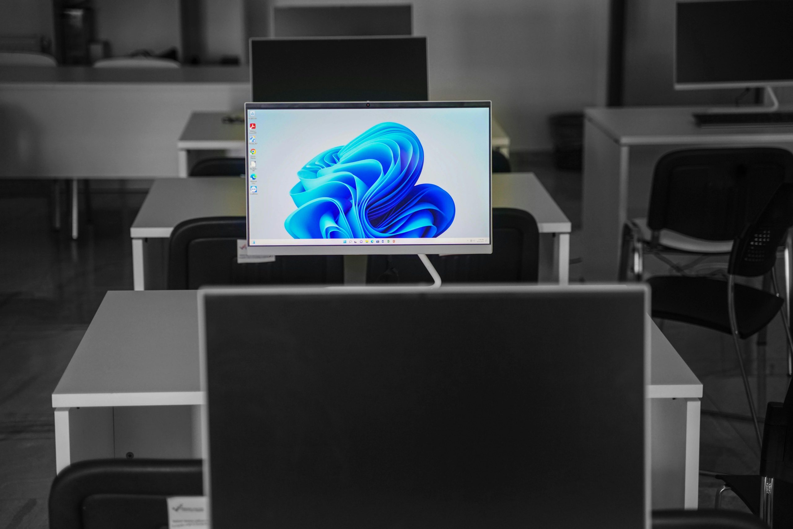 A Flat Screen Computer Monitor on a White Desk